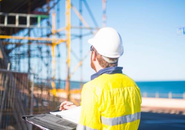 A person with a hard hat at a construction site