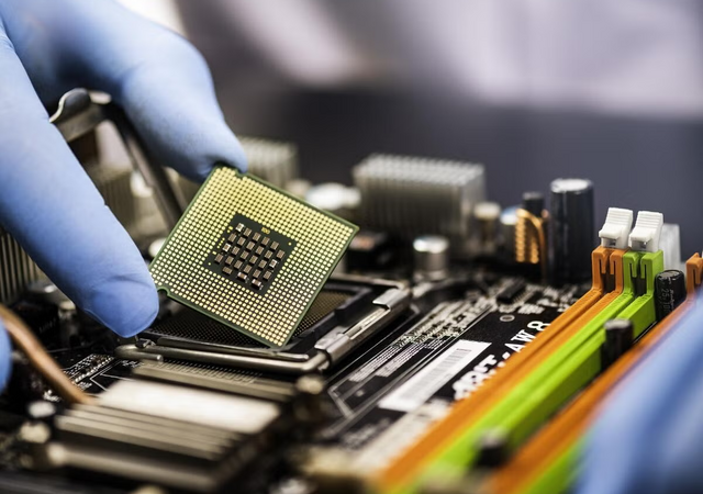 A person placing a computer chip