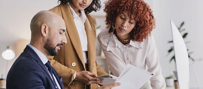 Three people working together