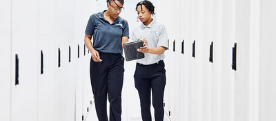 Two people working together in a data center