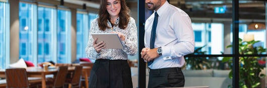 Two people working together on a tablet