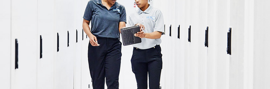 Two people working together in a data center