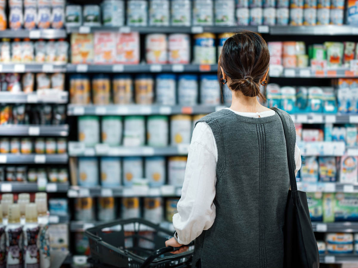 A person looking at products in a supermarket aisle