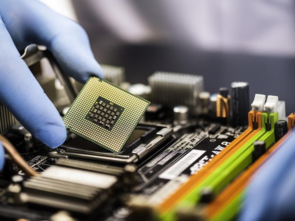 A person placing a computer chip