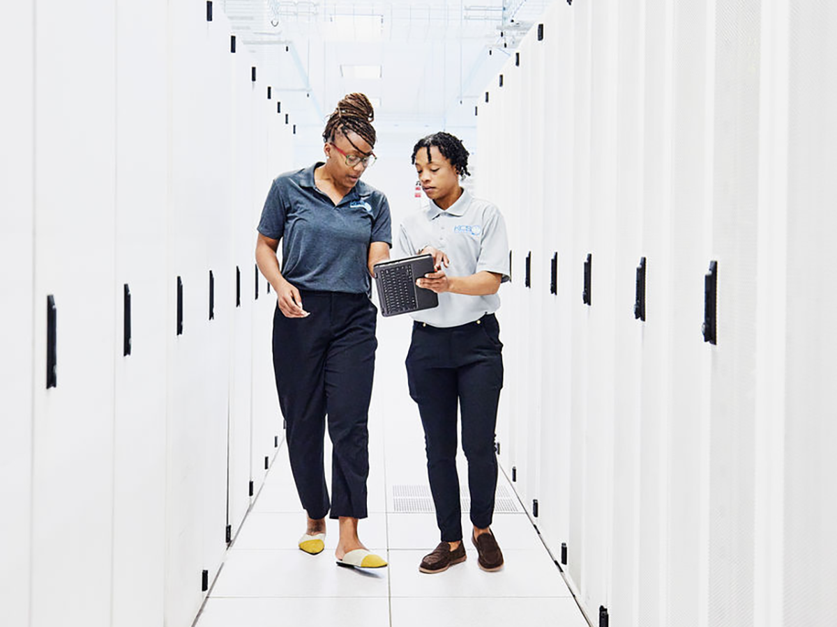 Two people working together in a data center